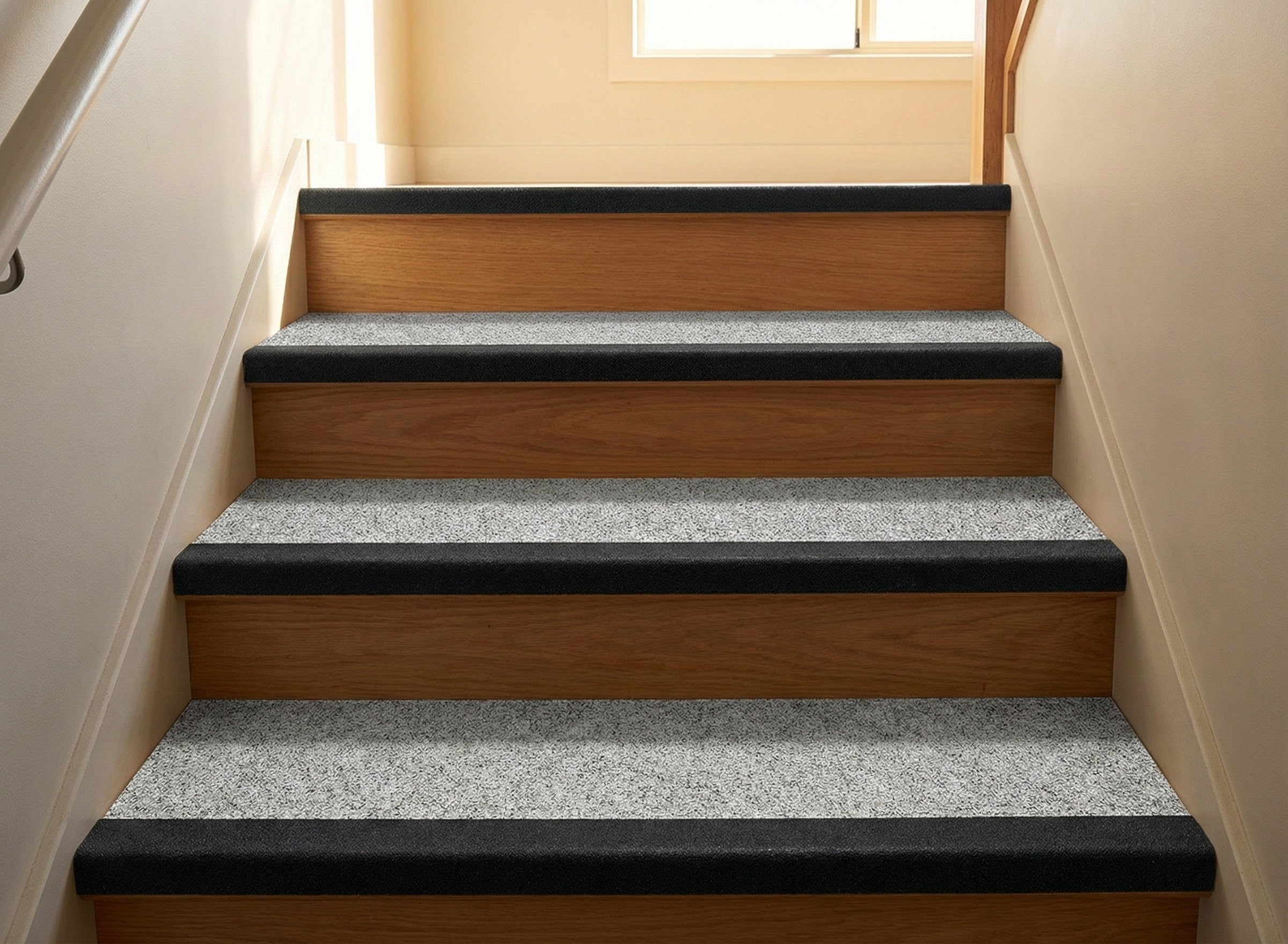 Anti-slip stair tread cover with black safety nosing installed on commercial stairs UK