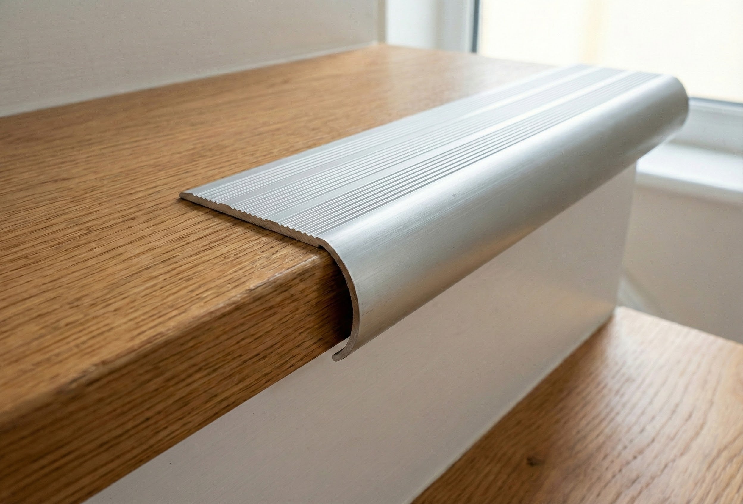 Professional aluminium bullnose stair nosing installed on UK staircase