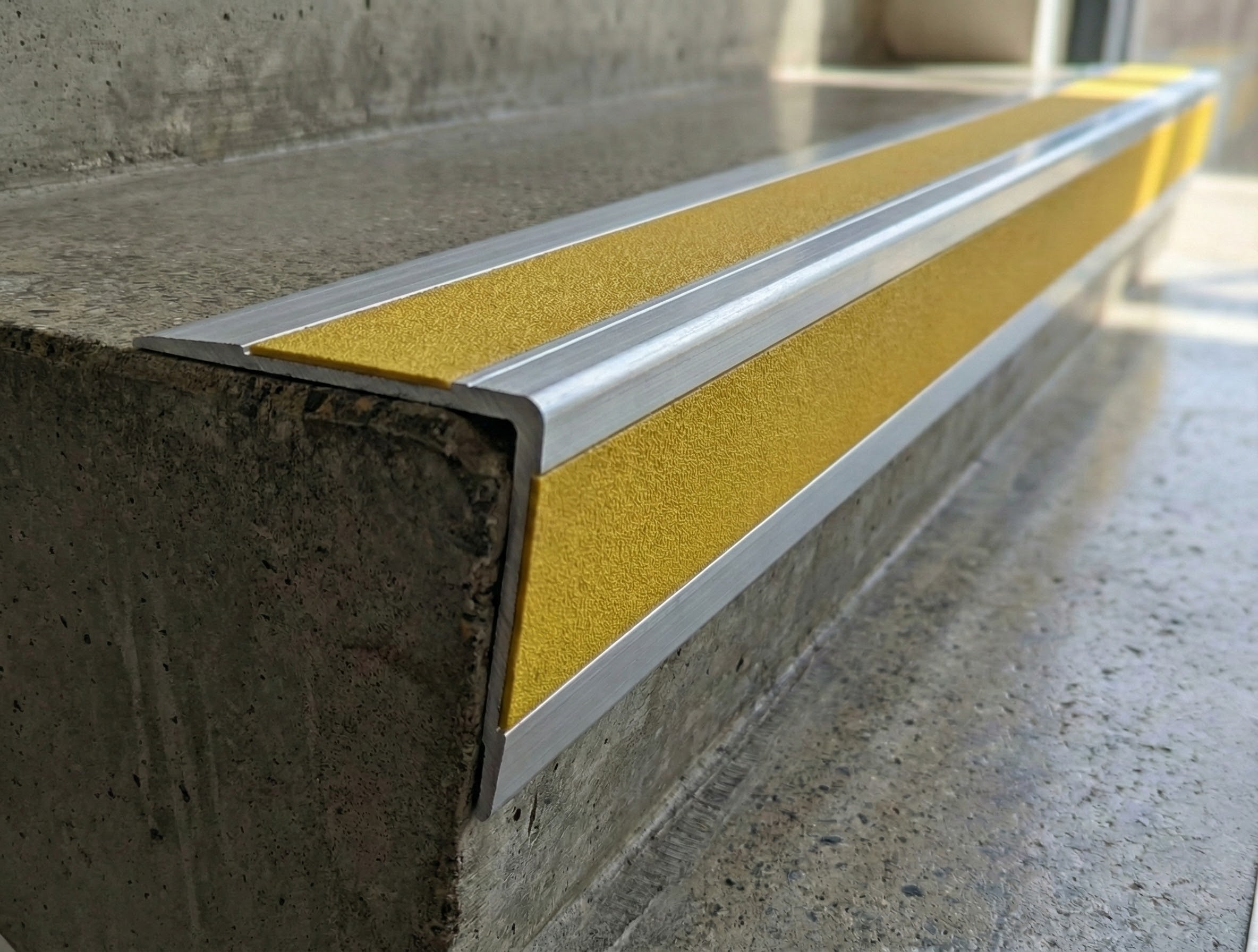 DDA Rake Back Aluminium Anti-Slip Stair Nosing installed on UK commercial staircase